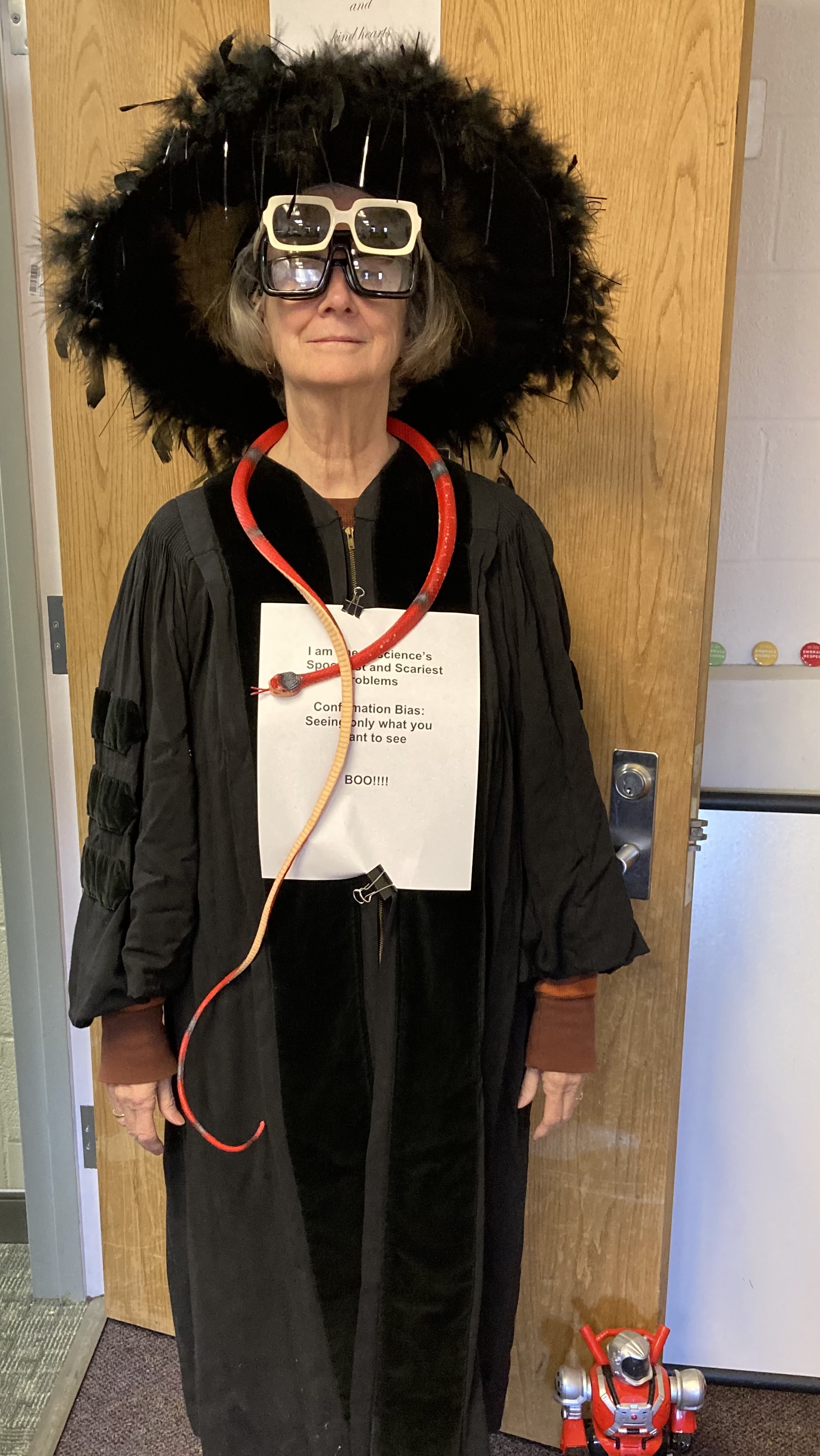 Dr. Cassidy's Halloween costume. On the paper: I am one of science’s spookiest and scariest problems. Confirmation bias: Seeing only what you want to see. Boo!