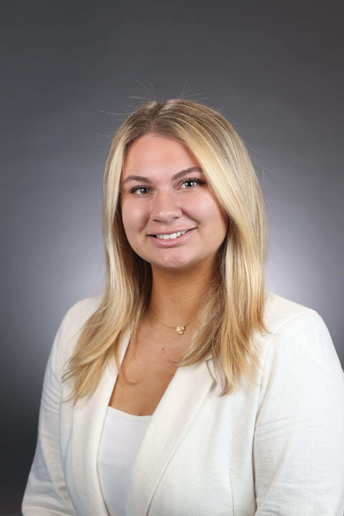 Picture of Molly in a white blazer smiling