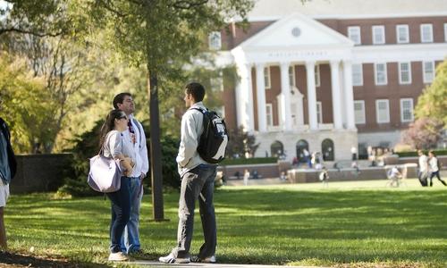 Students taslking near campus building