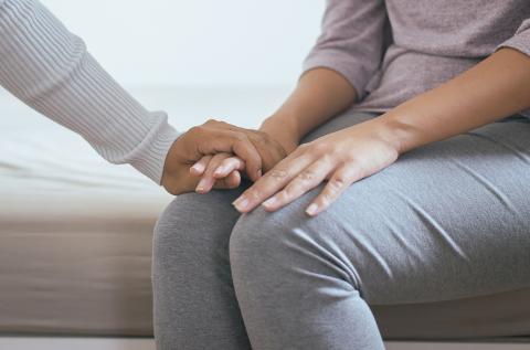 Parent receiving support; hands holding