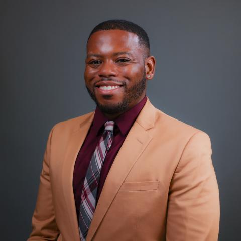 picture of Dr. Henry Willis in a brown sport jacket and tie