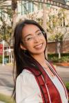 Image of Debbie Nguyen in front of palm trees