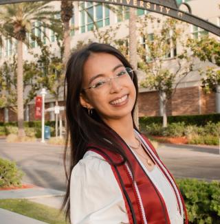 Image of Debbie Nguyen in front of palm trees