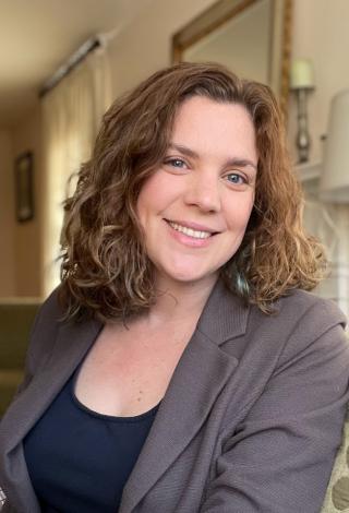 Dr. Jennifer Wessel facing and smiling at the camera, wearing a navy top and grey blazer. 